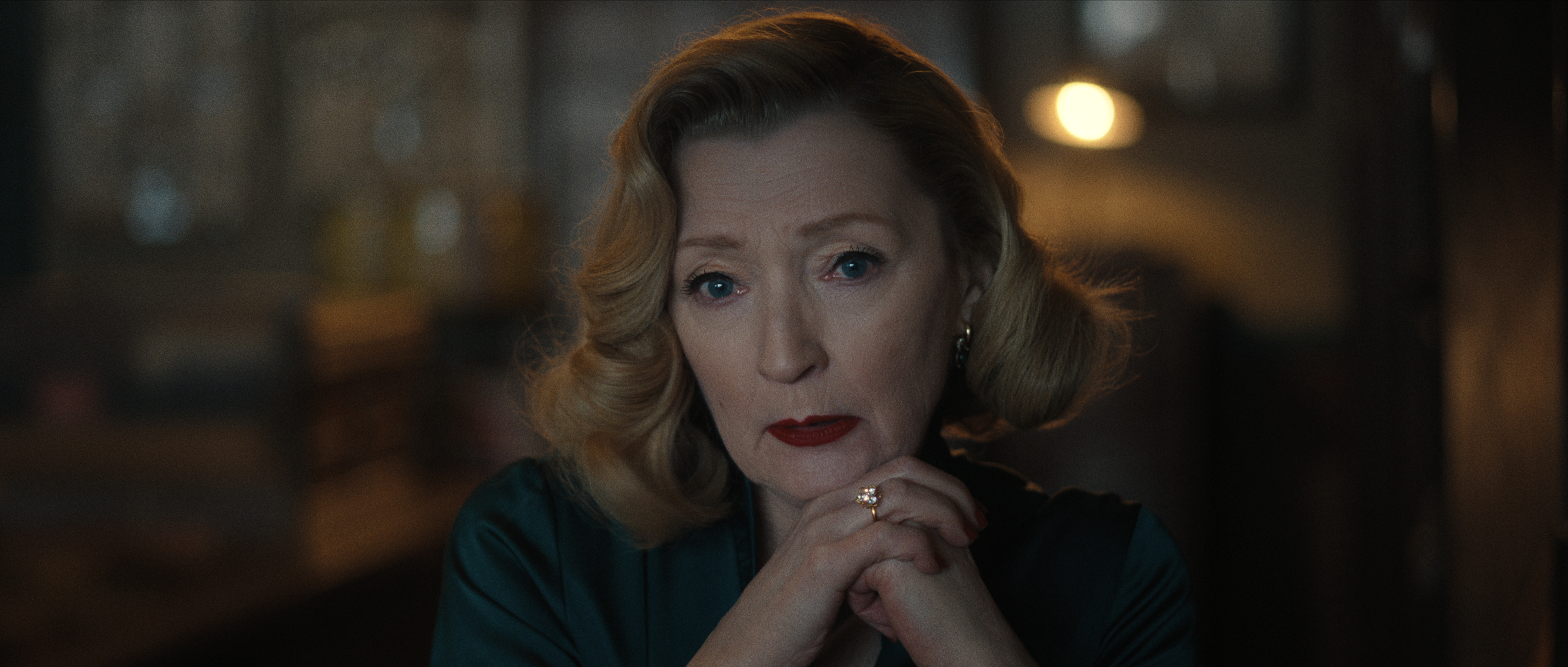 Lesley Manville as Bernice Worden resting her chin on her hands in monster the ed gein story