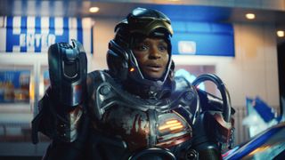 Riri Williams with her armored suit on and her mask retracted to show her face in Ironheart episode 5