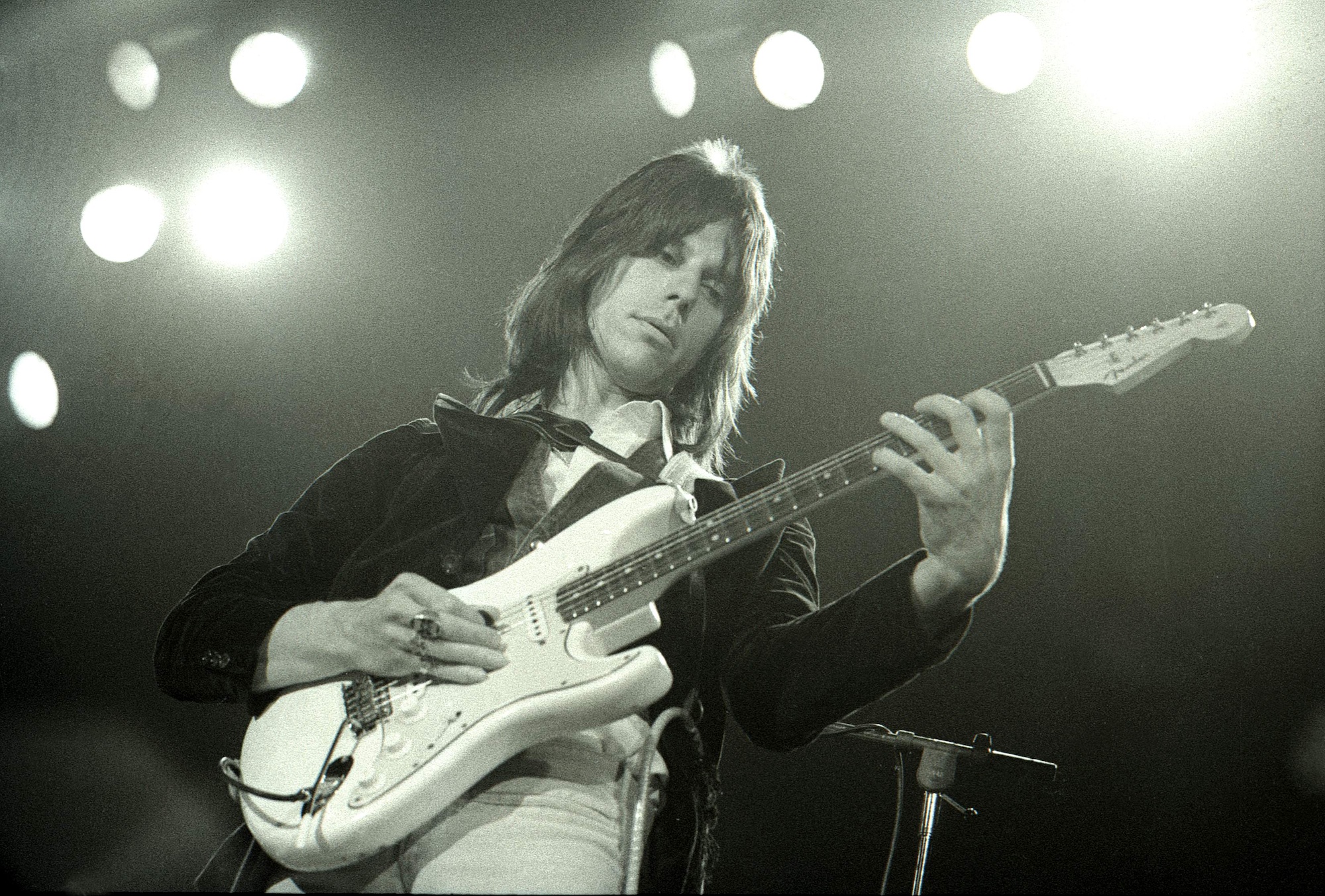 Jeff Beck wields a white Fender Stratocaster onstage