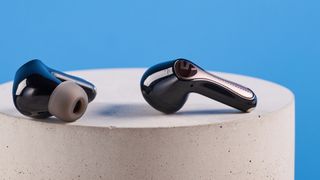 the soundpeats air5 pro earbuds in black and bronze with a black charging case and ear tips