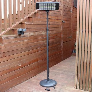 The Devola Core 2kW Freestanding Patio Heater assembled and stood on wooden decking