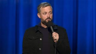 Nate Bargatze holding a mic during his Greatest Average American Netflix special.