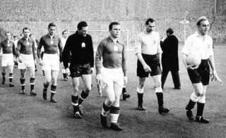 Ferenc Puskas (C) leading his team at Wembley Stadium of London prior to a friendly match against England. - Hungarian and Real Madrid football legend, the inspiration of the 'Mighty Magyars' national side that dominated world football in the 1950s, died 17 November 2006 after a long illness at 79.