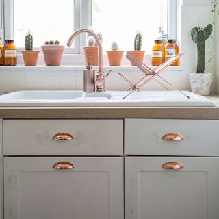 kitchen with white cabinet and wash basin with faucet