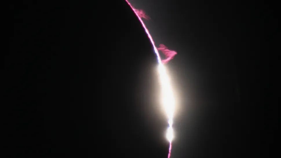 A photo of the eclipse with red plasma plumes around the sun&#039;s edge