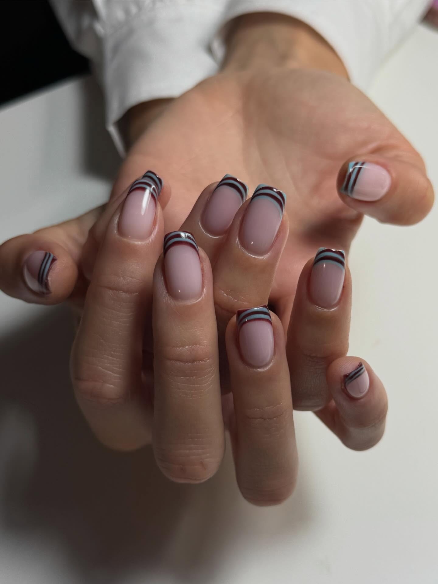 Burgundy and blue French nails.