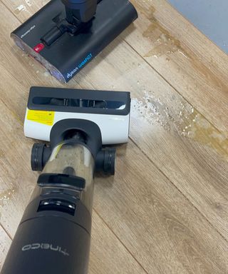 Tineco Floor One S7 Pro cordless wet vacuum and Dyson WashG1 on wooden floor in Future test center