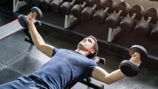 a photo of a man doing a dumbbell fly