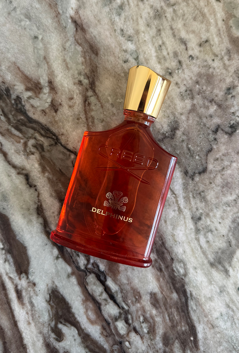 A photo of Creed Delphinus perfume on a marble surface
