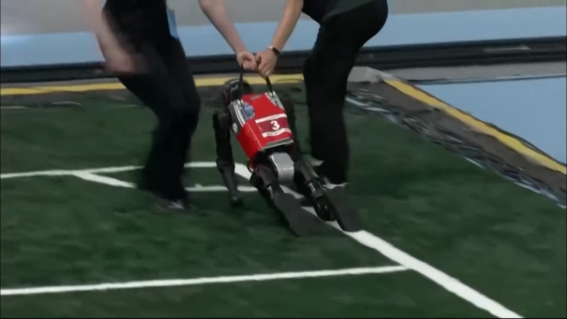 A robot being, err, removed from a football match at the first ever World Humanoid Robot Games