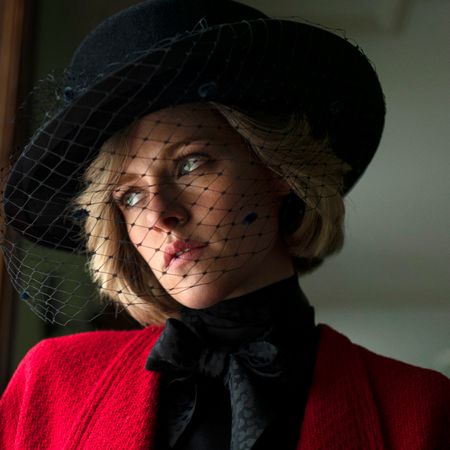 kristen stewart as princess diana wearing a black hat and red jacket in the movie spencer