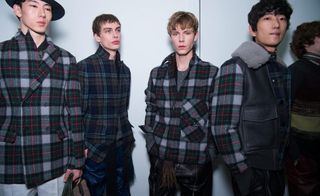 4 male models in plaid jackets stand together