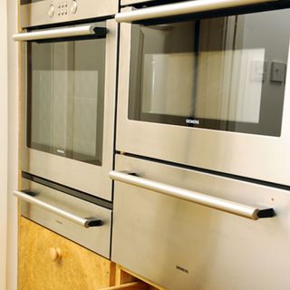 kitchen with ovens and microwave