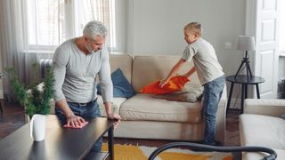 How to stay healthy and feel happy when working from home: a man and his son clean the house as a form of exercise