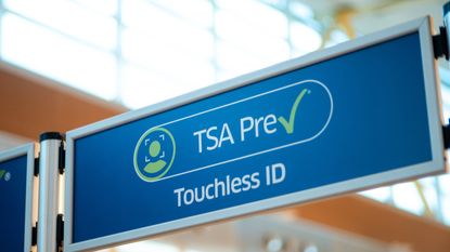 A close up of an airport security sign designating a lane for travelers with TSA PreCheck Touchless ID.