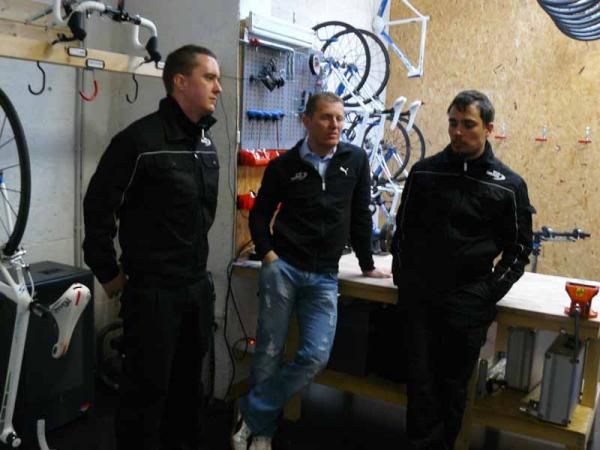 Sport Director and former pro Jens Heppner surrounded by mechanics Benny and Benjamin