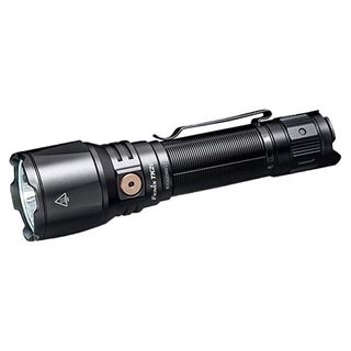 A Black flashlight lies horizonatally with the head facing towards the left on a white blank background