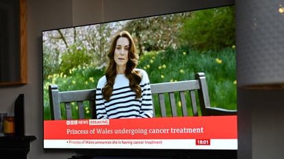 A relative of the photographer watches television, as Catherine, The Princess of Wales announces that she is receiving a preventative course of chemotherapy for cancer on March 22, 2024 in London, England. 