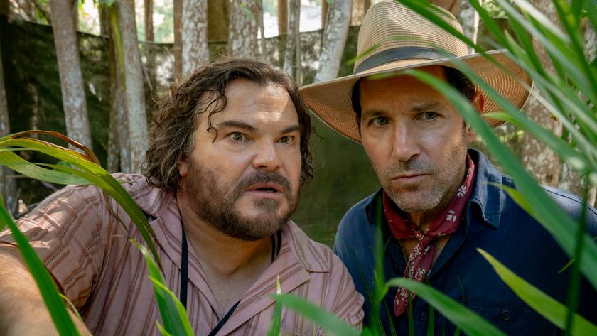 Jack Black as Doug and Paul Rudd as Griff in Anaconda (2025), peering out from behind some leaves