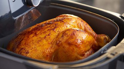 Philips Air Fryer XXL with a whole chicken in it