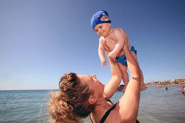 Mother and son both enjoy the water on holiday.