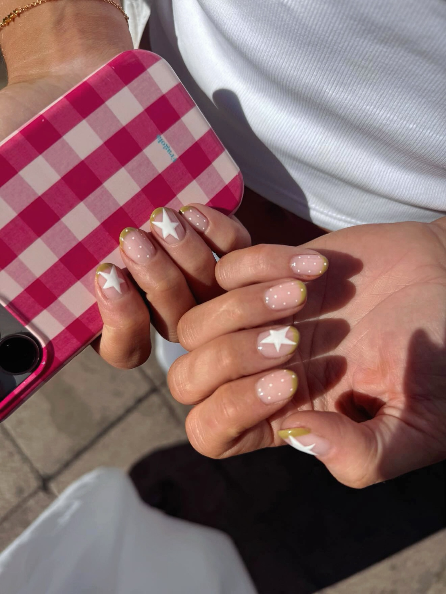 An assorted nail design with stars and polka dots.