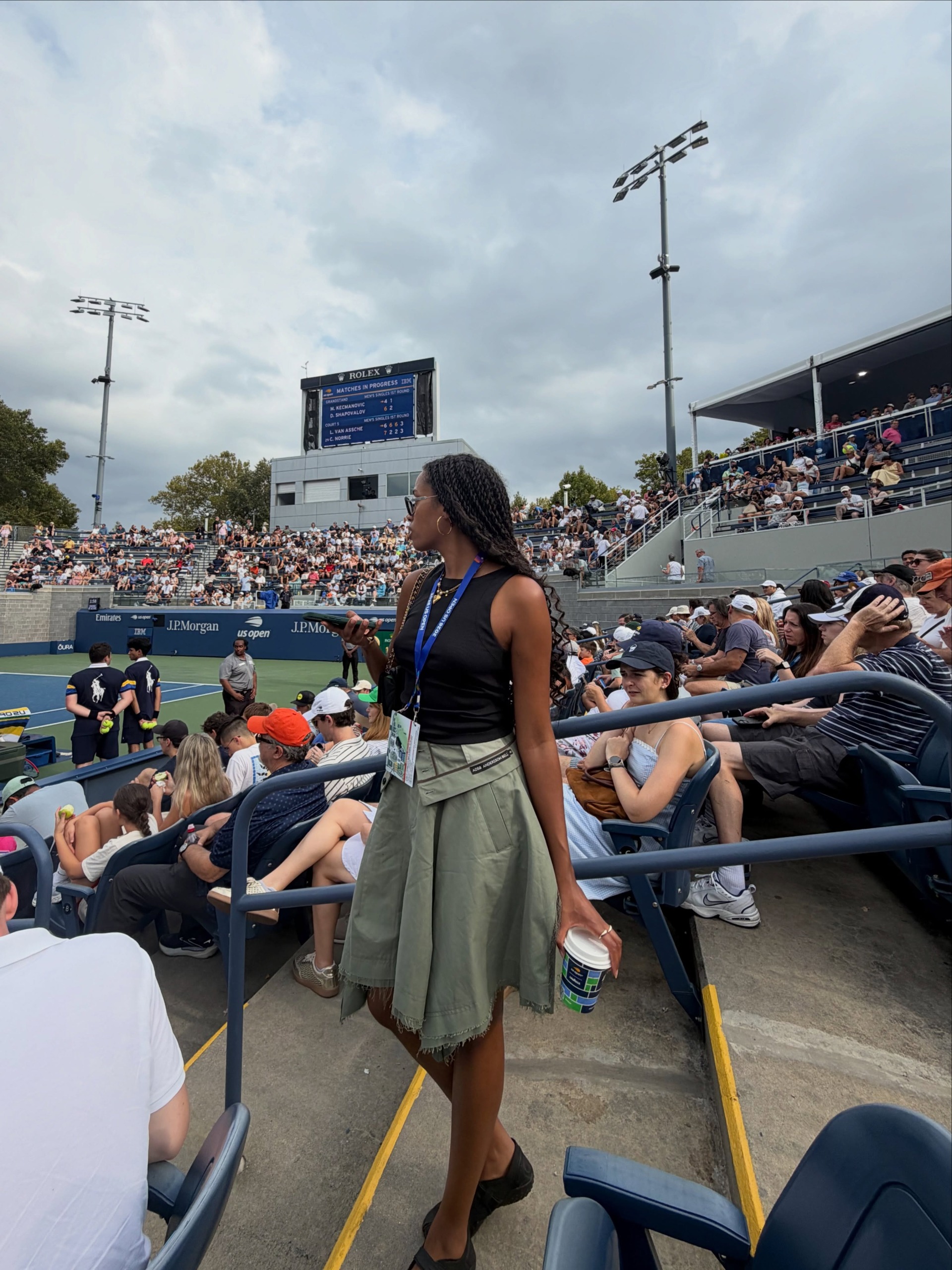 Woman wearing a tank top and utility skirt.