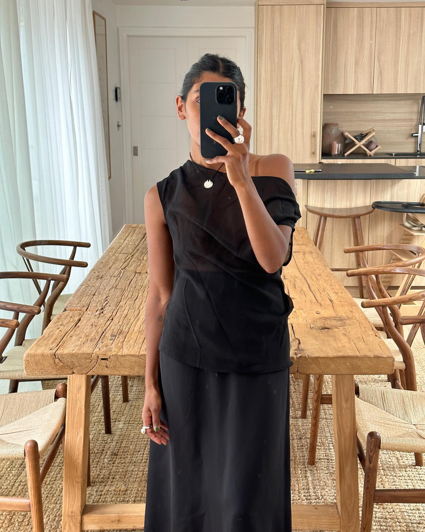 An image of @monikh wearing a sheer blouse.
