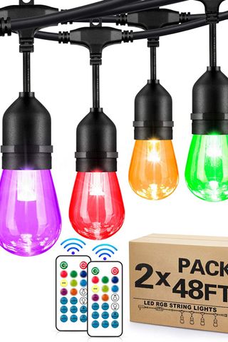 multicolored outdoor lights from Amazon alongside two remote controls and packaging