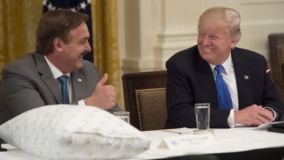 US President Donald Trump speaks alongside Mike Lindell (L), founder of My Pillow, during a Made in America event with US manufacturers in the East Room of the White House in Washington, DC, 