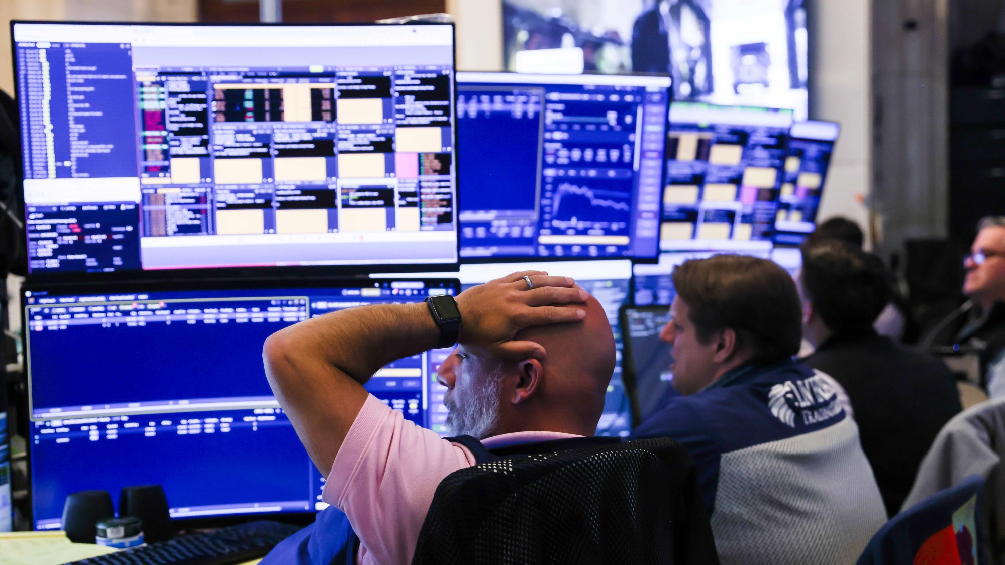 Traders watch screens on the floor of the New York Stock Exchange