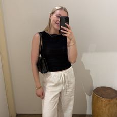 Woman in dressing room wearing linen waistcoat and linen trousers