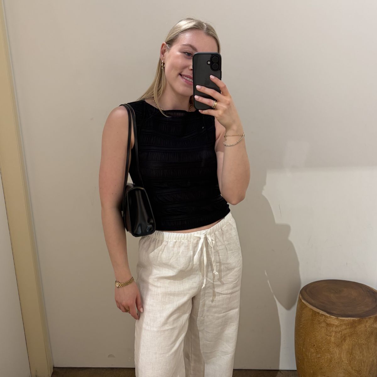 Woman in dressing room wearing linen waistcoat and linen trousers
