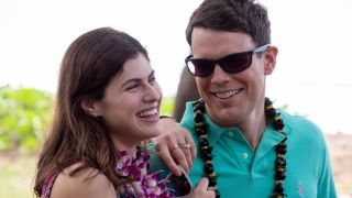 Alexandra Daddio and Jake Lacy standing together and smiling in Season 1 of The White Lotus.