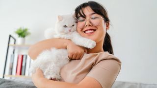 Woman hugging cat