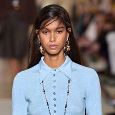 A model wearing a blue top