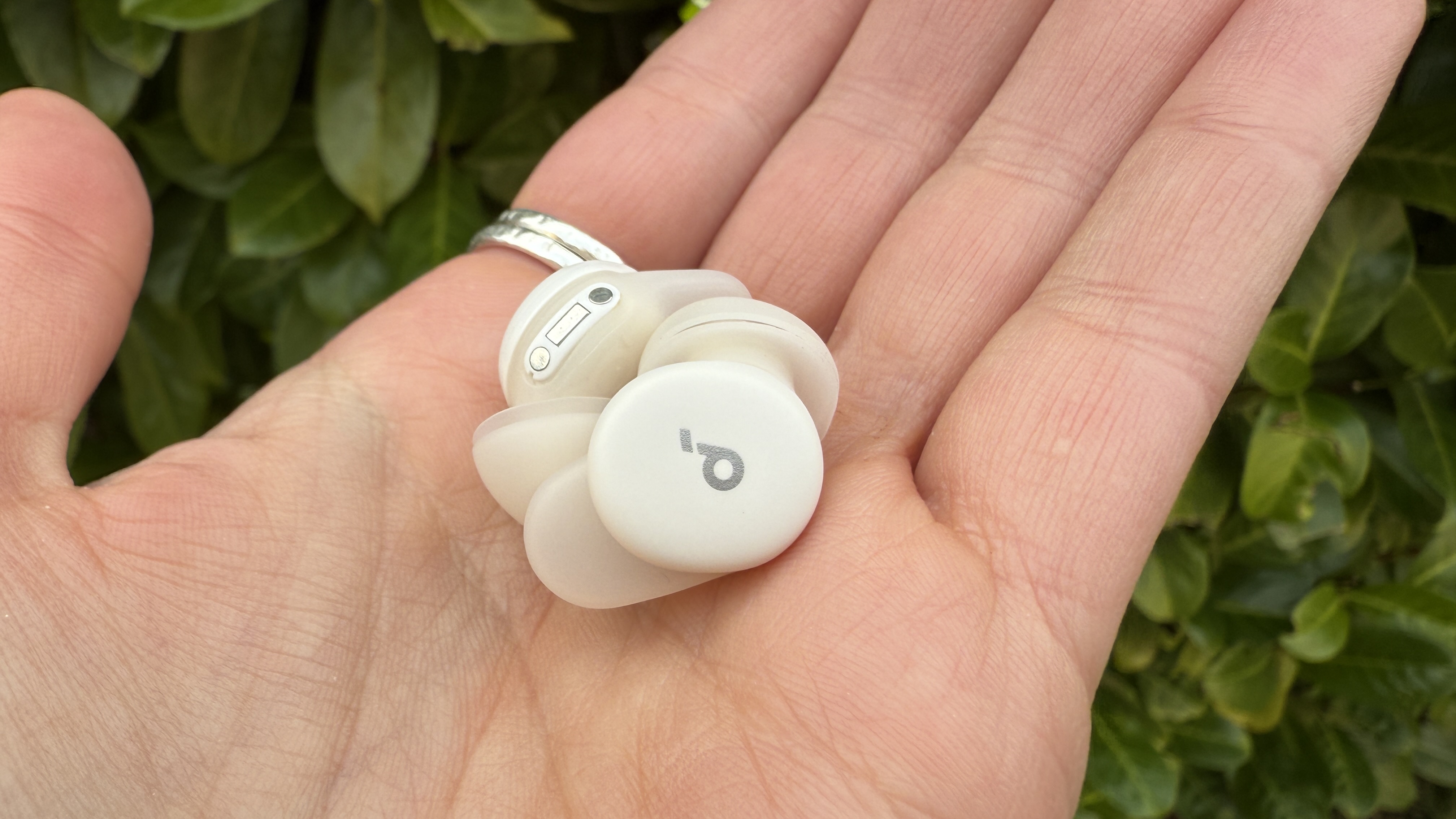 Someone holding the soundcore sleep a30 buds