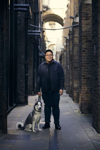 Hanson Cheng in alley with dog