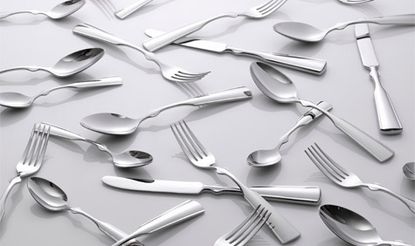 Mixed metal cutlery on table