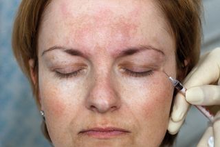 Woman receives botox injection