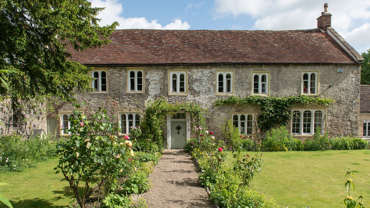 Exterior of a listed stone house in somerset in summer