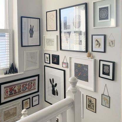 gallery wall with with white staircase and window