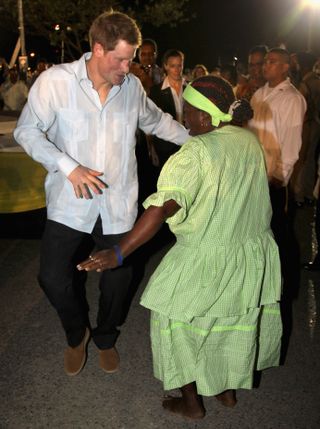 Prince Harry takes part in a dance as he attends a Jubilee Block Party on March 2, 2012 in Belmopan, Belize