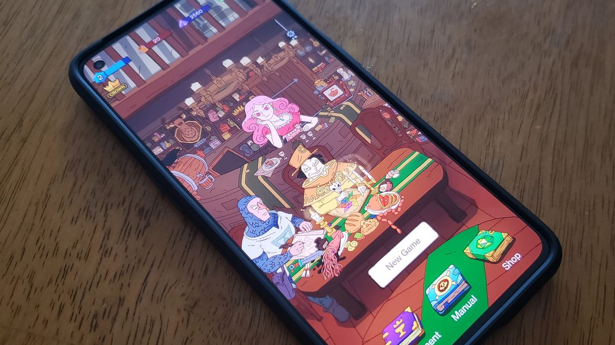 A phone sits on a table with the tavern from Dicey Elementalist showing on the screen. 