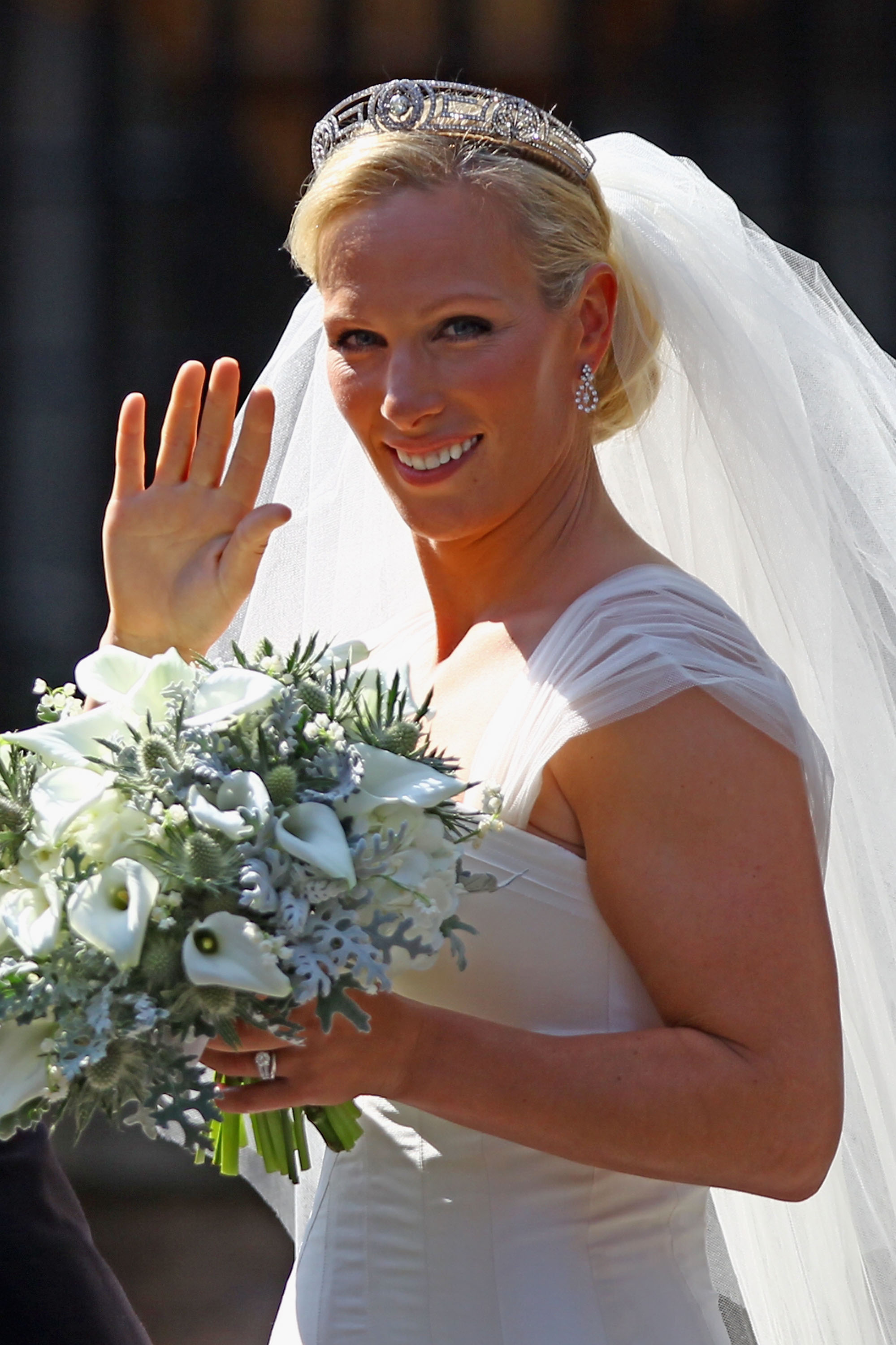 Zara Tindall wearing a wedding gown and tiara waving to the camera