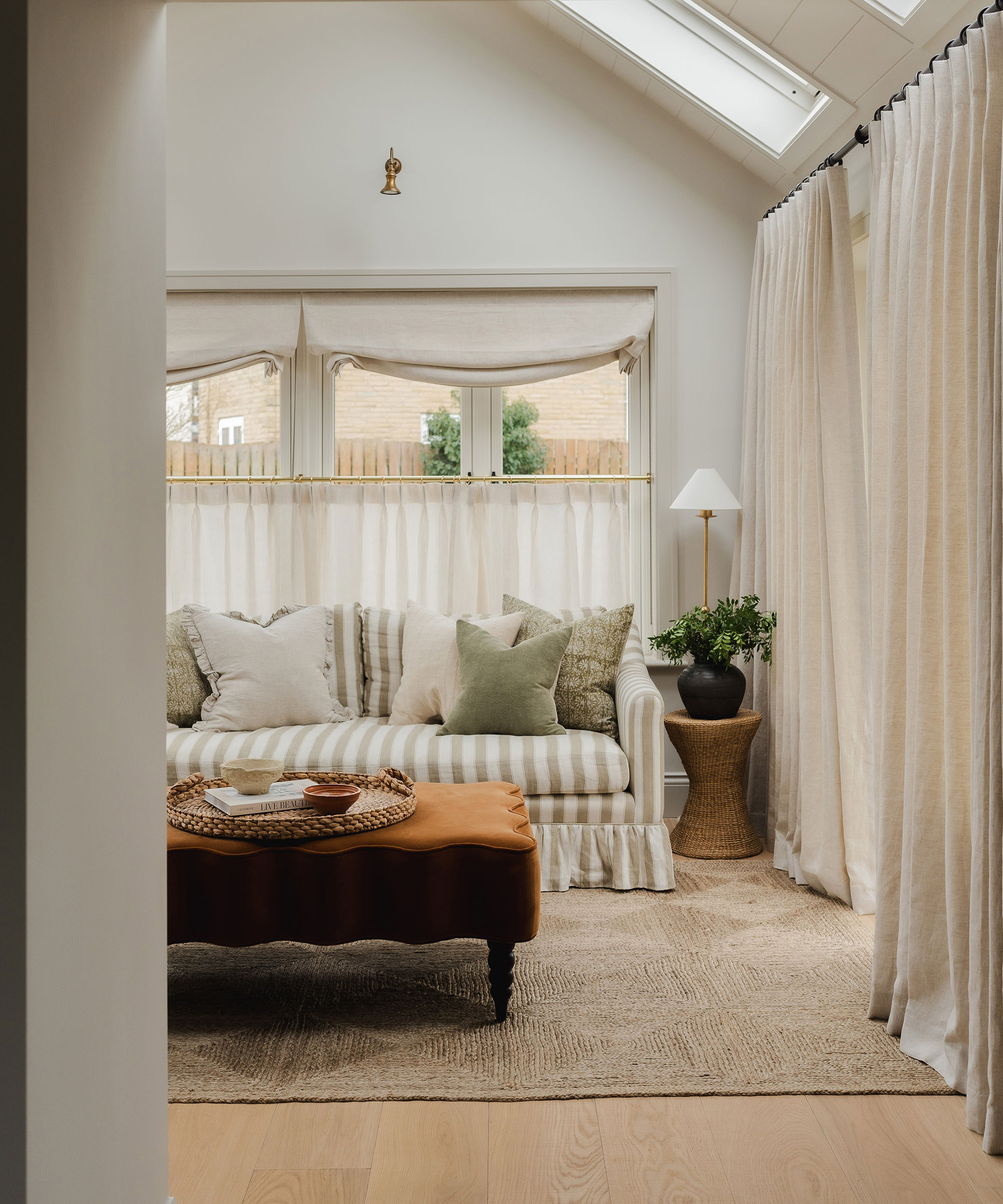 cost conservatory living room with curtains and wooden flooring