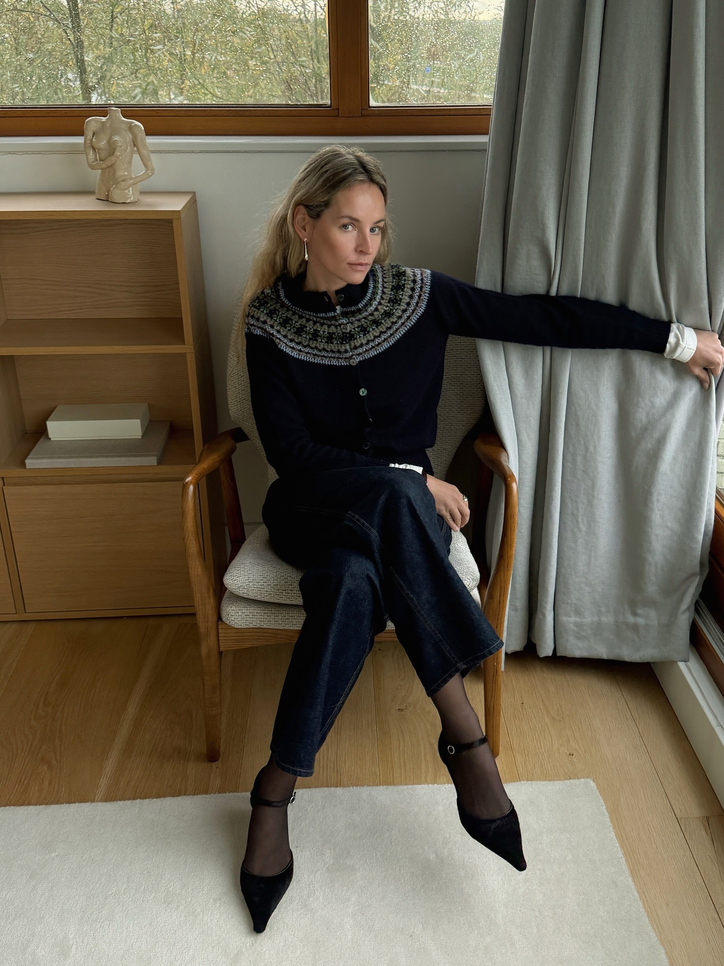 Anouk Yve wears a fair isle sweater with trousers and t-strap heels.