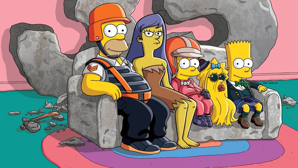 The Simpsons family sits on a couch