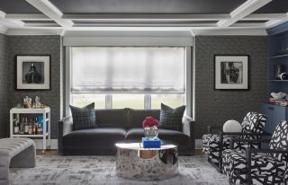living room with charcoal grey sofa and patterned grey wallpaper