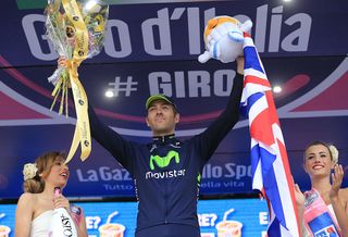 British Alex Dowsett celebrates on the podium winning the 555kms eigth stage of the 96th Giro dItalia time trial from Gabicce Mare to Saltara on May 11 2013 in Saltara ItalyBriton Alex Dowsett took the honours ahead of compatriot Bradley Wiggins in the Tour of Italys eighth stage time trial on Saturday with Italian Vincenzo Nibali inheriting the leaders pink jersey AFP PHOTO LUK BENIES Photo credit should read LUK BENIESAFP via Getty Images